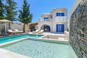 a villa with a swimming pool in front of a house at Villa Kalymnos by Villa Plus in Kolymbia