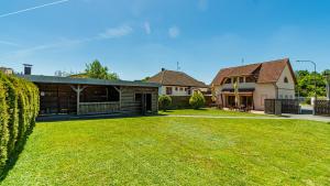 a house with a large yard with a house at Penzion Adria III in Dobrohoř