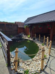 a pond in the yard of a house at Penzión U Tonky in Tomek