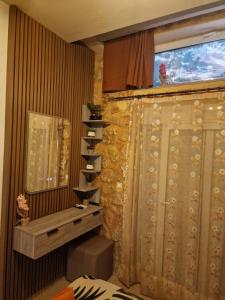 a bathroom with a shower curtain and a window at Errik Luxury House in Faliraki +21 photos