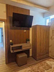 a living room with a flat screen tv on a wall at Errik Luxury House in Faliraki