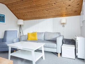 a living room with a couch and a table at 4 person holiday home in Lemvig in Lemvig
