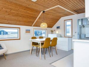 a kitchen and dining room with a table and chairs at 4 person holiday home in Lemvig in Lemvig