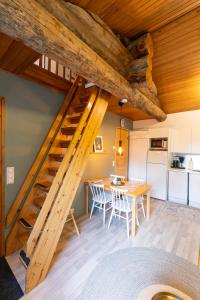 a kitchen and dining room with a wooden staircase in a house at Voimakelo - renovated - near ski bus in Kuusamo