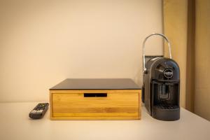 a black printer sitting next to a wooden box at B&B Hipponion in Vibo Valentia