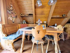 a dining room with a wooden table and chairs at Haus Paradiesecke in Waldbrunn +17 photos