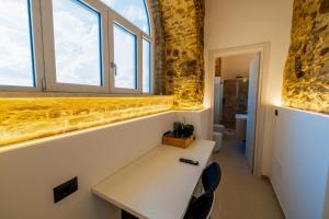 a room with a table and two windows at B&B Hipponion in Vibo Valentia +54 photos