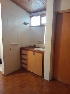 a small bathroom with a sink and a window at Arpegio Hostel in San Rafael +21 photos