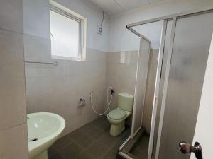 a bathroom with a shower and a toilet and a sink at The Rock Hotel in Nuwara Eliya +38 photos