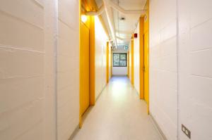 an empty hallway in a building with yellow walls at Résidences du Cégep de Rimouski in Rimouski +17 photos