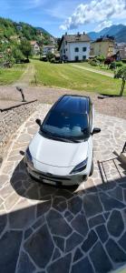 a white car parked on a stone driveway at Appartamento EDELWEISS in Baselga di Pinè +38 photos