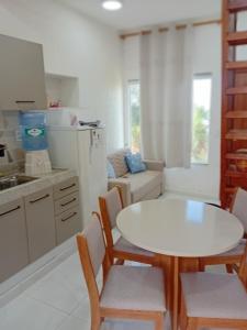 a kitchen with a white table and chairs in a kitchen at Triplex com linda vista para o mar de Parati Anchieta ES in Anchieta