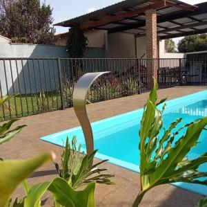 a swimming pool in a yard with a fence at Espaço Manacá in Dourados