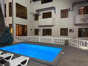 a swimming pool in front of a building at Capital Hotel in Yerevan