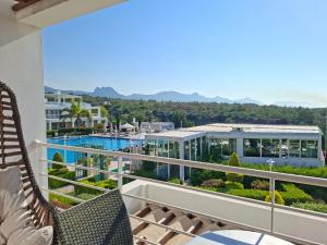 a balcony with chairs and a view of a pool at Sun Valley 2-bedroom apartment in Nicosia International Airport