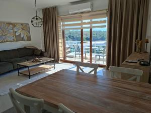a living room with a wooden table and a living room with a view at Sun Valley 2-bedroom apartment in Nicosia International Airport