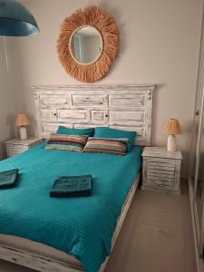 a bedroom with a bed with a mirror on the wall at Sun Valley 2-bedroom apartment in Nicosia International Airport +17 photos