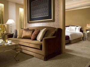 a living room with a couch and a bed at Sofitel Harbin in Harbin