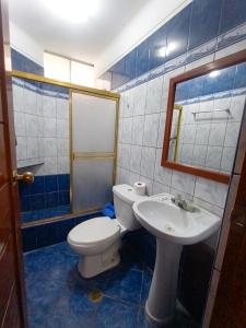 a bathroom with a toilet and a sink at Hotel Plaza Grau in Trujillo +36 photos