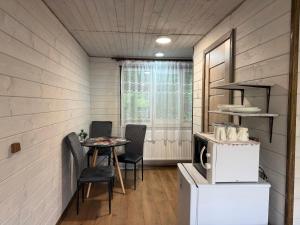 a small dining room with a table and chairs at Шепіт лісу in Bukovets