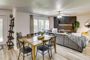 a living room with a table and a couch at Fire Pit & Stunning Lake Views: Shell Knob Home! in Shell Knob