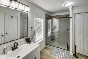 a bathroom with a sink and a glass shower at Fire Pit & Stunning Lake Views: Shell Knob Home! in Shell Knob +24 photos