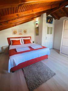 a bedroom with a large bed with orange pillows at Ceres26 in Fethiye