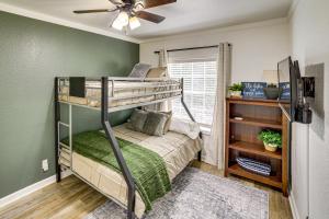 a bedroom with two bunk beds and a ceiling fan at Fire Pit & Stunning Lake Views: Shell Knob Home! in Shell Knob