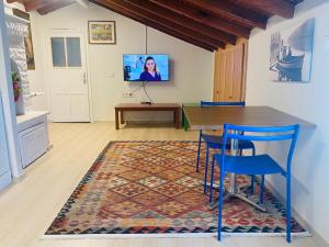 a dining room with a table and chairs and a tv at Ceres26 in Fethiye