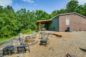 a cabin with chairs and a fire pit in front of it at Fire Pit & Stunning Lake Views: Shell Knob Home! in Shell Knob