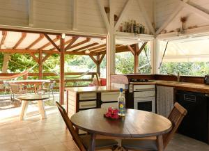 a kitchen with a table with a bottle on it at Kazabat à Marie-Galante in Grand-Bourg