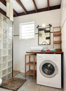 a washing machine in a bathroom with a sink at Kazabat à Marie-Galante in Grand-Bourg