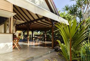 a pavilion with a table and chairs on a patio at Kazabat à Marie-Galante in Grand-Bourg +18 photos