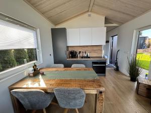 a kitchen with a large wooden table and chairs at Weitblick- Sauna- WLAN- Haus 3 in Neheim-Hüsten