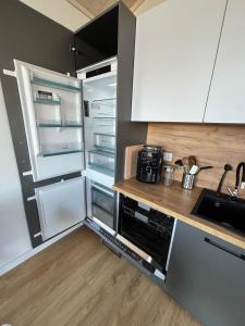 a kitchen with an open refrigerator and a counter at Weitblick- Sauna- WLAN- Haus 3 in Neheim-Hüsten +20 photos