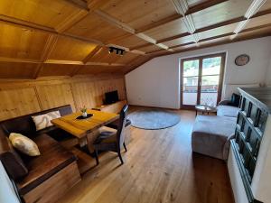 a living room with a table and a couch at Winklern Appartment Wildschütz in Kitzbühel