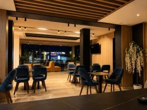 a conference room with chairs and tables and a television at Hotel Mare in Ksamil