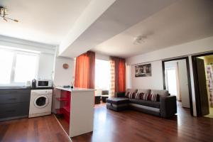 a living room with a couch and a table at Dor de Mare - Piata Ovidiu Constanta in Constanţa