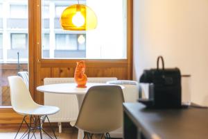 an orange cat statue sitting on a white table at Studio 28 Kaprun inkl Sommerkarte in Kaprun +8 photos