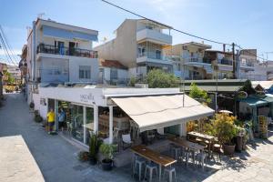a building with awnings and tables and chairs in a street at Margarita Fresh Studios in Potos