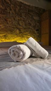 a towel sitting on top of a bed at Loucy’s Art Home in Mandria +42 photos