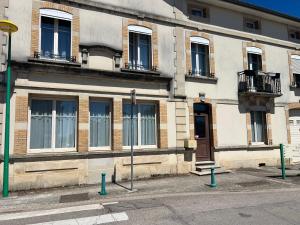 a building with windows and balconies on a street at Chambre bleue in Vigneulles-lès-Hattonchâtel