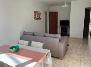 a living room with a couch and a table at Departamentos en Chivilcoy in Chivilcoy
