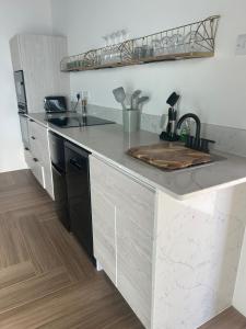 a kitchen with a sink and a counter top at The Cottage in Saint Georgeʼs