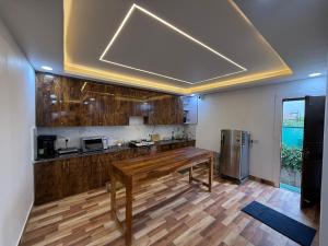 a kitchen with a wooden counter top in a room at oliv Faram house in Greater Noida