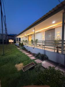 a house with a lawn in front of it at oliv Faram house in Greater Noida