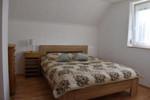 a bed with two pillows on it in a bedroom at Bozóki Apartman in Kiskunmajsa +7 photos