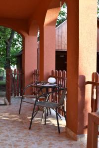 a table and chairs sitting on a patio at Bozóki Apartman in Kiskunmajsa