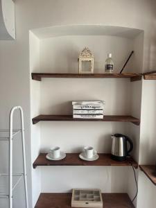 a shelf in a kitchen with two cups on it at Affittacamere Ca' Vecia in Riccò del Golfo di Spezia