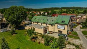 an overhead view of a house with a green roof at Penzion a Restaurace Adria II in Dobrohoř